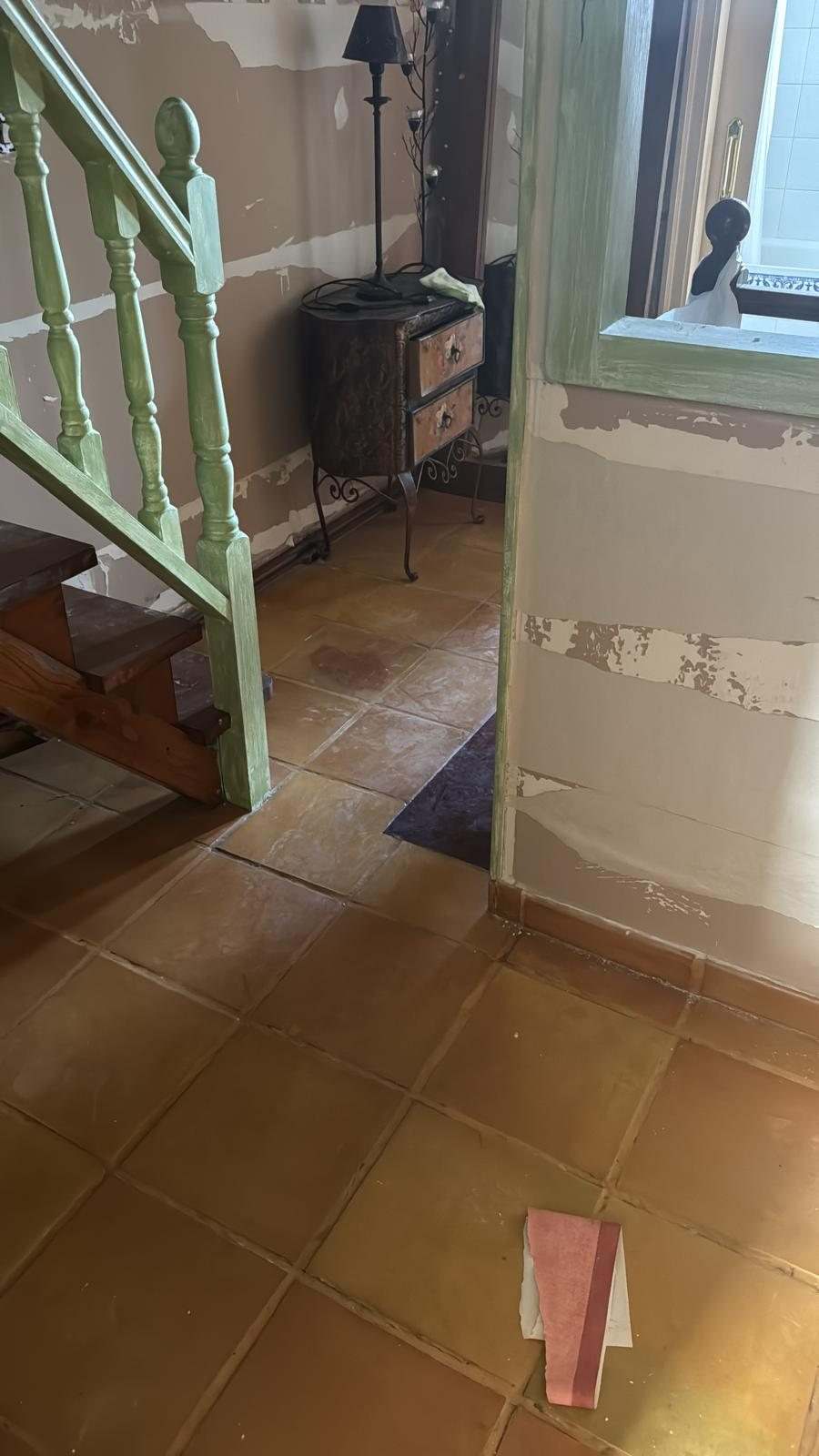 Pie de la escalera con las paredes a medio sanear